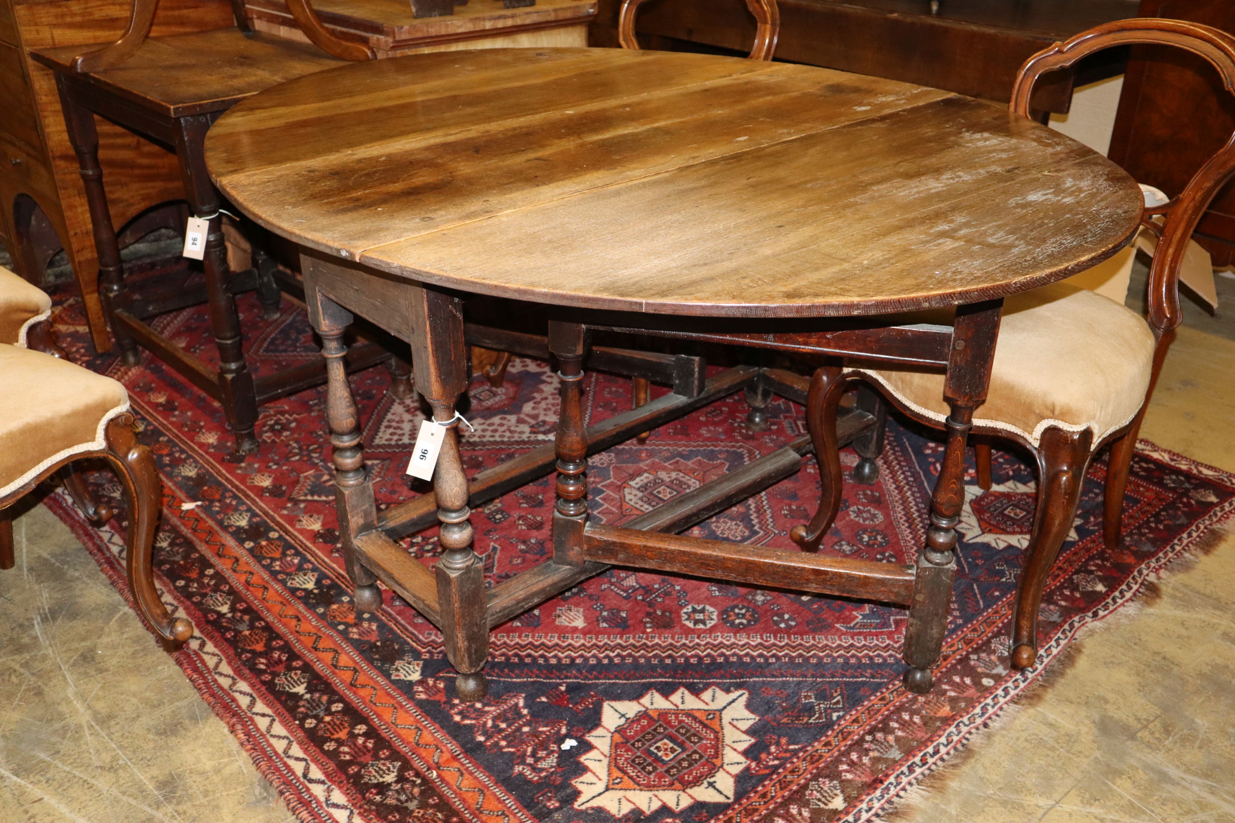 An early 18th century oak gateleg dining table, width 144cm extended, height 70cm
